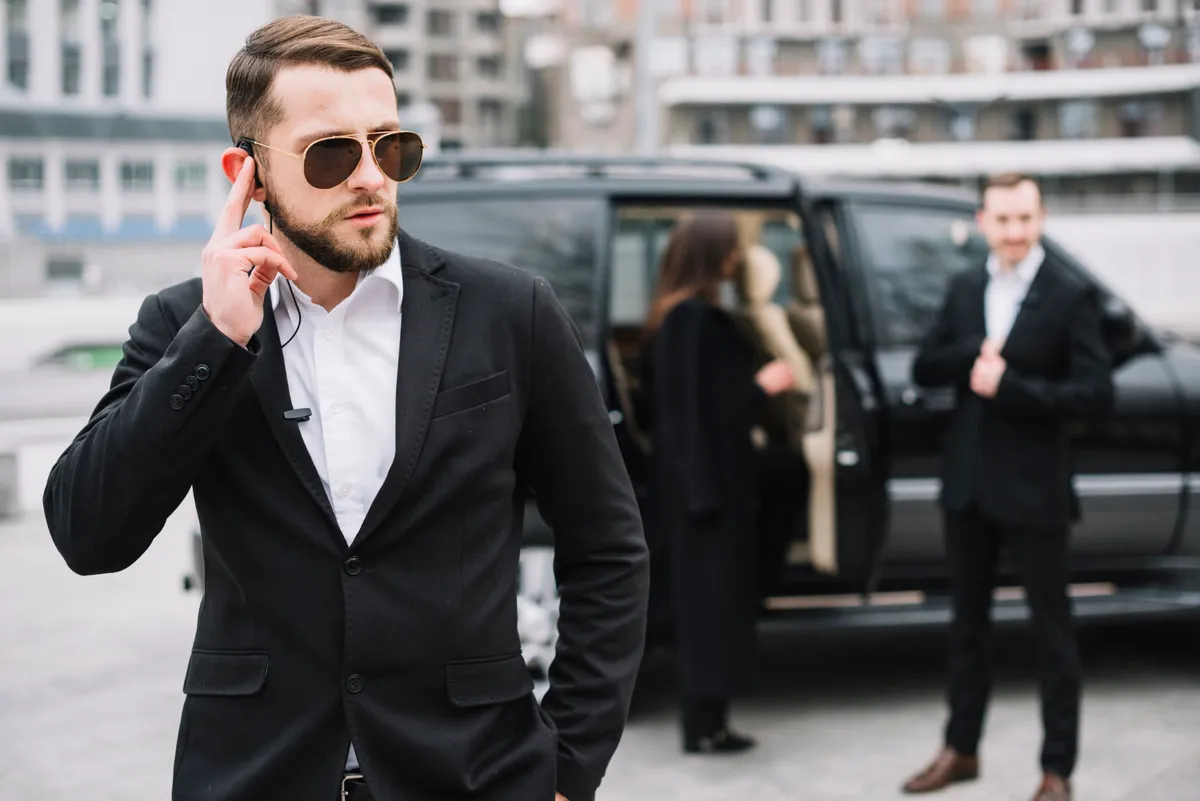 Suited security professional using an earpiece