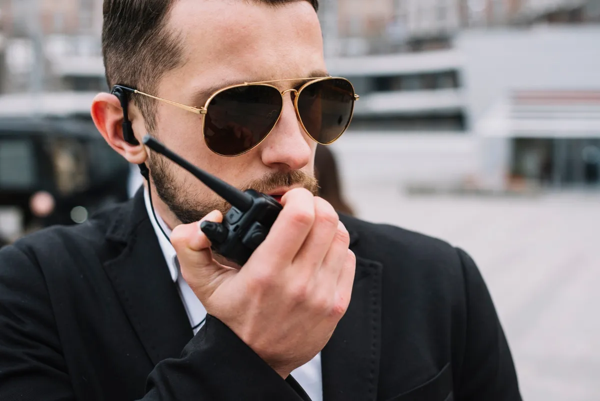 Security professional communicating by handheld radio